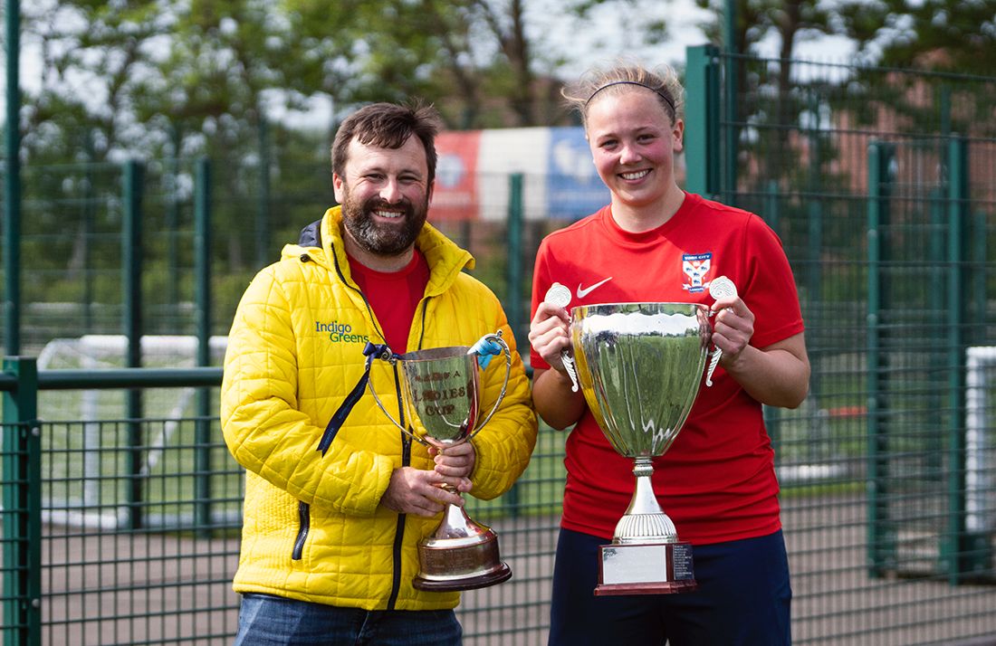 Alice Hughes of York City Ladies Football Club holding Trophies with Simon of Indigo Greens Estate Agents