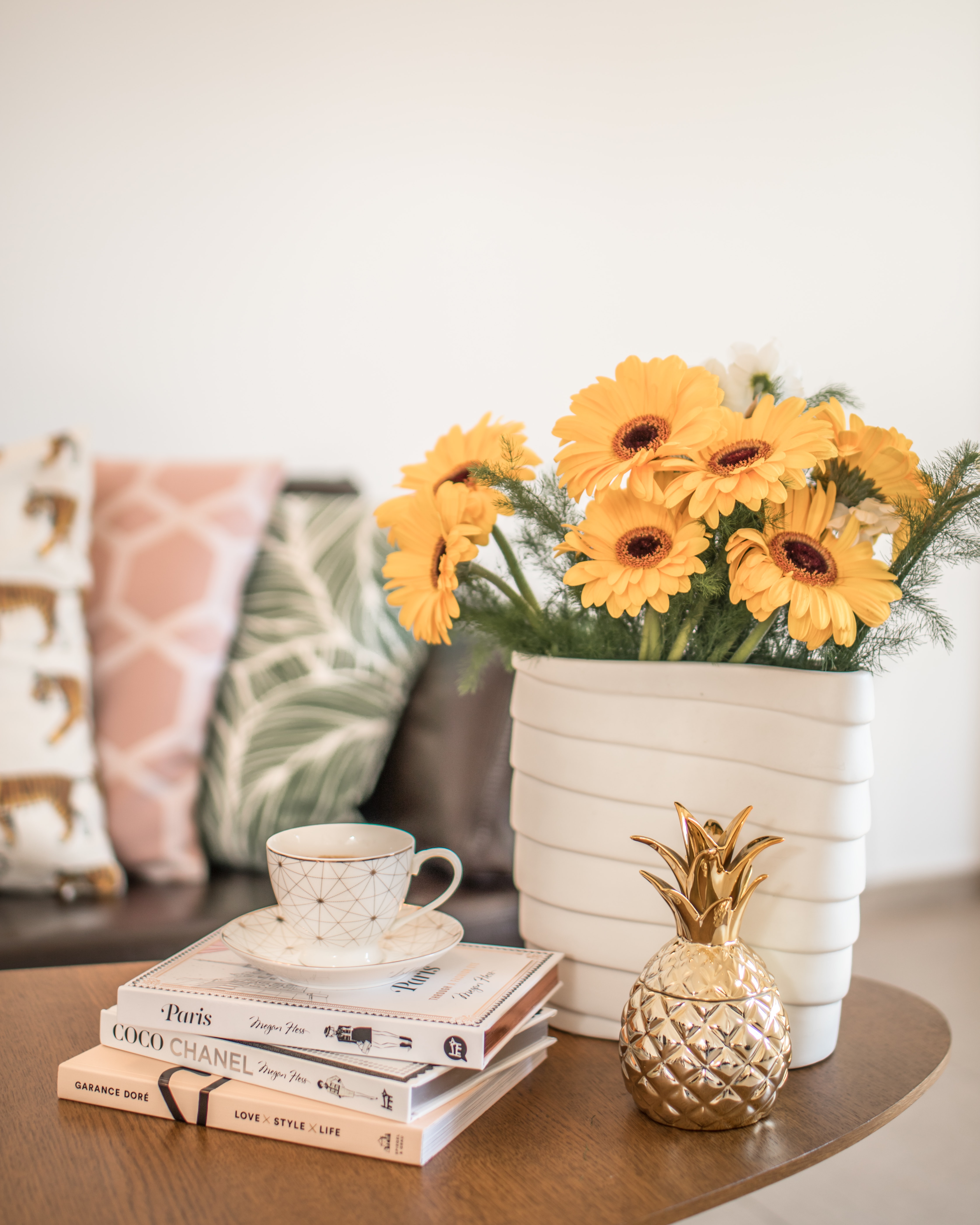 Yellow Flowers in a vase and books on a coffee table